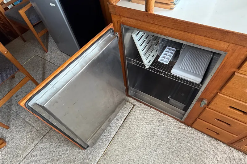 Slide: The Image of Open refrigerator in 1969 Grand Banks 42 Classic boat interior. - 28
