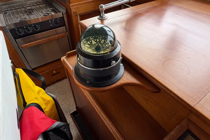 Slide: The Image of 1969 Grand Banks 42 Classic interior with compass and stove. - 27