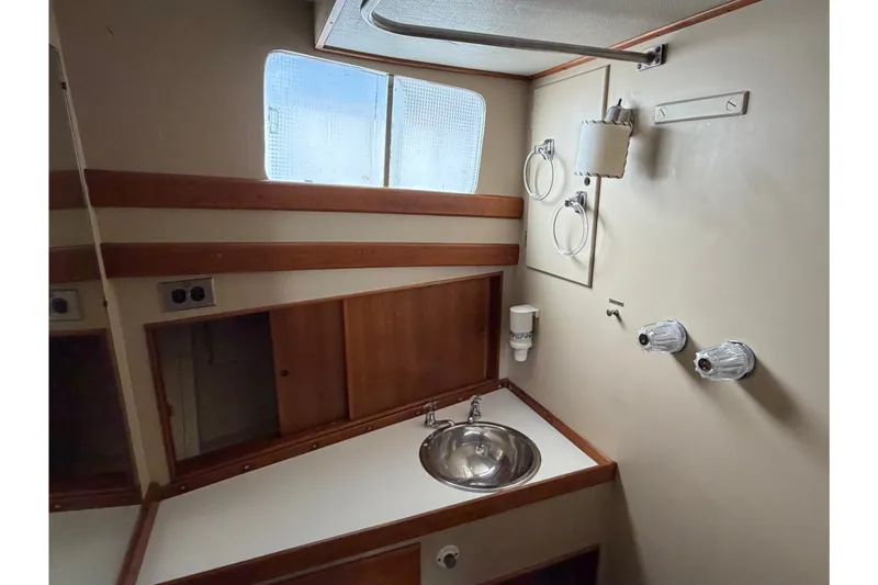 Slide: The Image of Bathroom interior of 1969 Grand Banks 42 Classic yacht, featuring sink and wooden cabinetry. - 38