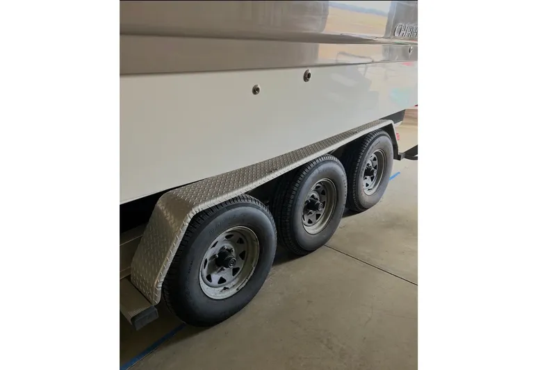 Slide: The Image of Trailer wheels of a 2008 Chaparral Signature 290 boat in a garage. - 14
