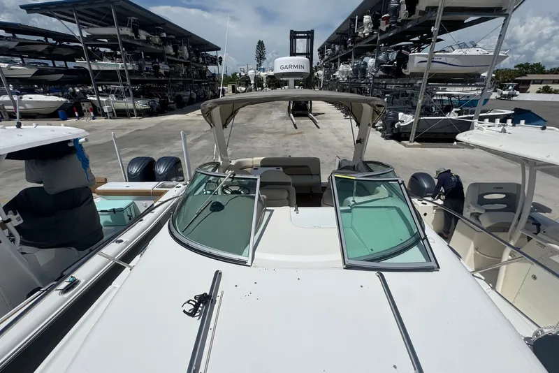 Slide: The Image of 2008 Chaparral Signature 290 boat docked at a marina with multiple vessels. - 42