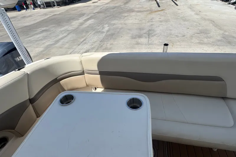 Slide: The Image of 2008 Chaparral Signature 290 boat interior with cushioned seating and table. - 52