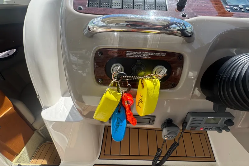 Slide: The Image of Control panel of a 2008 Chaparral Signature 290 boat with keys and safety equipment. - 63