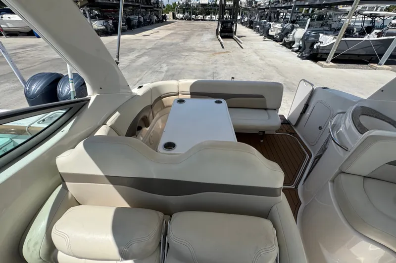 Slide: The Image of 2008 Chaparral Signature 290 boat interior with seating and table, docked in a marina. - 48
