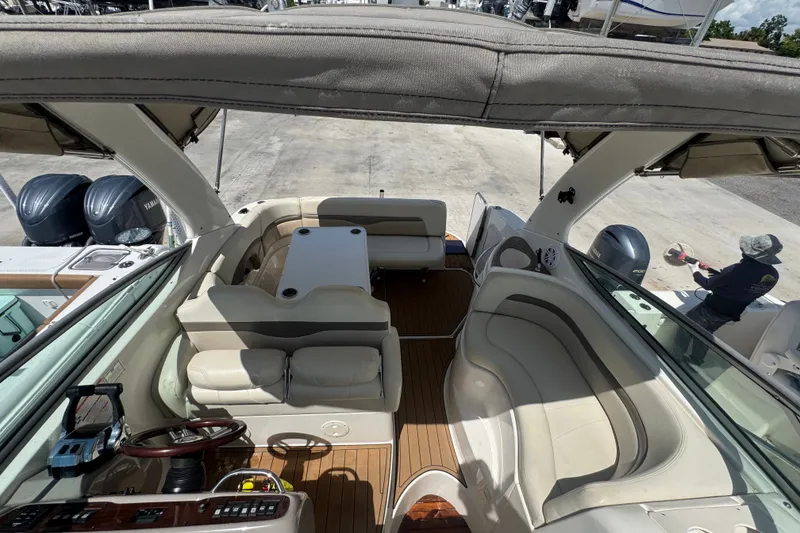 Slide: The Image of 2008 Chaparral Signature 290 boat interior with seating and table, docked outdoors. - 47