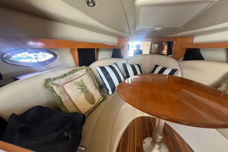 Slide: The Image of 2008 Chaparral Signature 290 interior with plush seating and wooden table. - 26