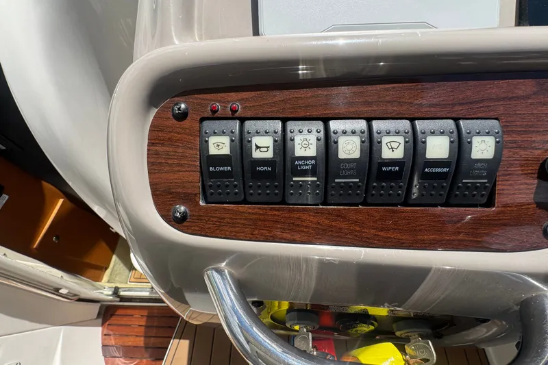 Slide: The Image of Control panel of a 2008 Chaparral Signature 290 boat with various switches. - 56