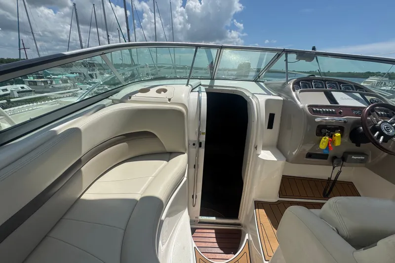 Slide: The Image of 2008 Chaparral Signature 290 boat interior with helm, seating, and open cabin door. - 19