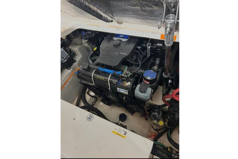 Slide: The Image of Engine compartment of a 2008 Chaparral Signature 290 boat, showcasing mechanical components. - 13