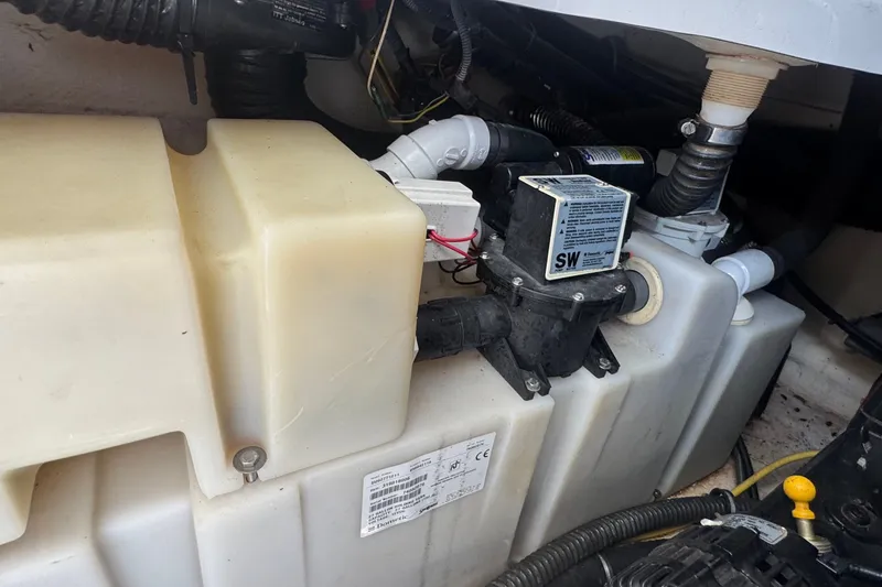 Slide: The Image of Engine compartment of a 2008 Chaparral Signature 290 boat, featuring a water pump system. - 74