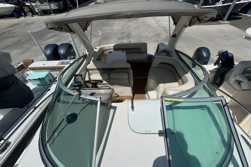 Slide: The Image of 2008 Chaparral Signature 290 boat interior with seating and dashboard, docked at marina. - 44