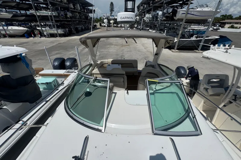 Slide: The Image of 2008 Chaparral Signature 290 boat docked, featuring open cockpit and Garmin equipment. - 43