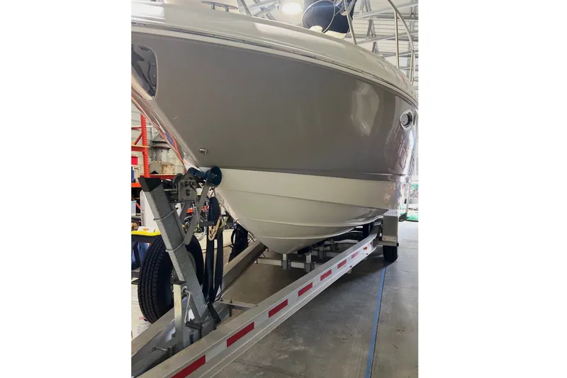 The Image of A 2008 Chaparral Signature 290 boat on a trailer inside a warehouse. - 0