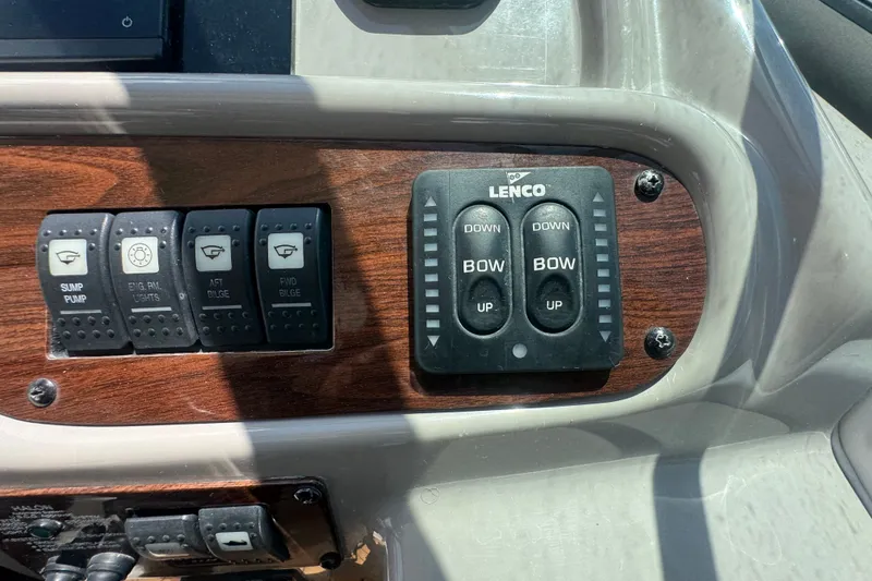 Slide: The Image of Control panel of a 2008 Chaparral Signature 290 boat with switches and Lenco trim tab controls. - 58