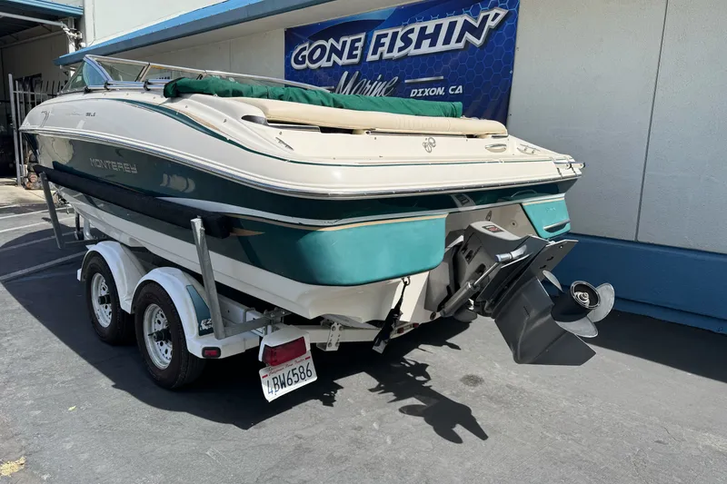 Slide: The Image of 2000 Monterey 190LS Montura boat on trailer, parked outside a marine shop. - 7