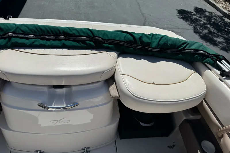 Slide: The Image of 2000 Monterey 190LS Montura boat interior with cushioned seating and green cover. - 24