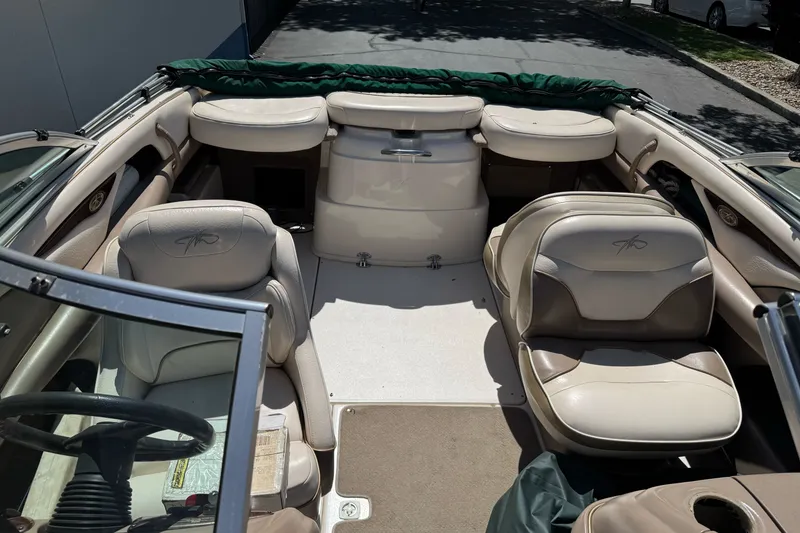 Slide: The Image of Interior of a 2000 Monterey 190LS Montura boat with beige seating and steering wheel. - 23