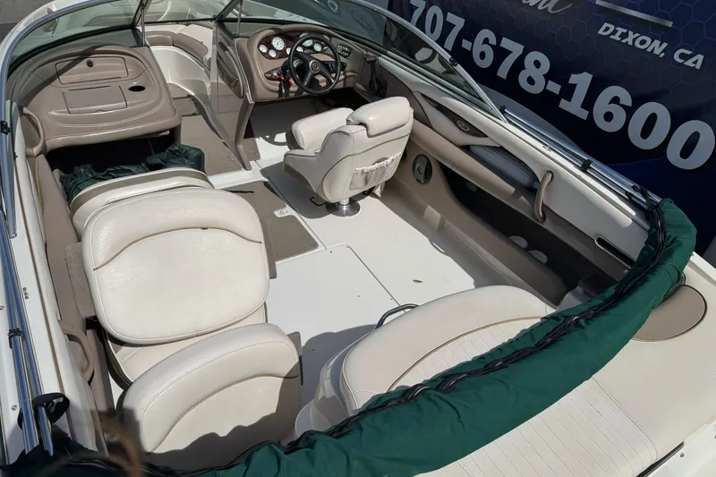 Slide: The Image of 2000 Monterey 190LS Montura boat interior with beige seating and steering console. - 9