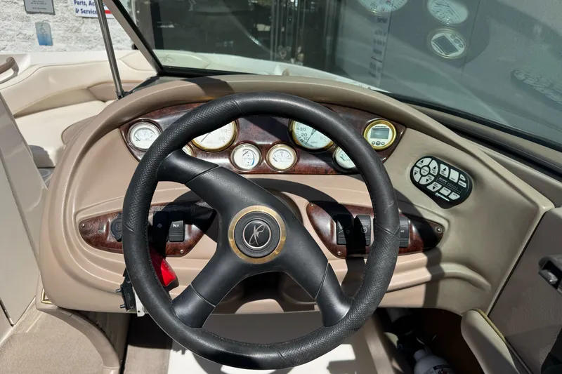 Slide: The Image of Steering wheel and dashboard of 2000 Monterey 190LS Montura boat, featuring gauges and controls. - 18