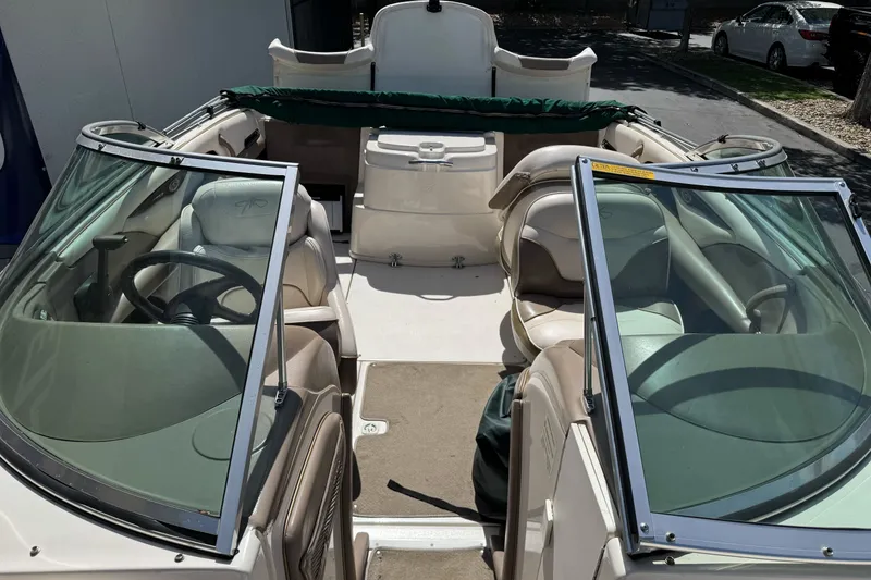 Slide: The Image of 2000 Monterey 190LS Montura boat interior with seating and steering wheel, parked outdoors. - 15