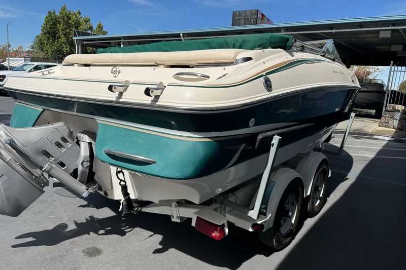 Slide: The Image of 2000 Monterey 190LS Montura boat on trailer, parked outdoors under clear sky. - 5