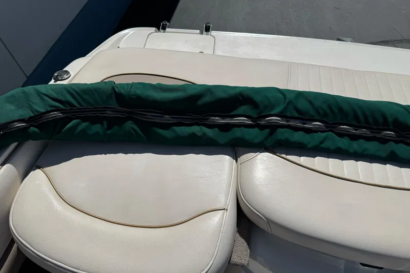 Slide: The Image of 2000 Monterey 190LS Montura boat interior with green cover on white seats. - 25