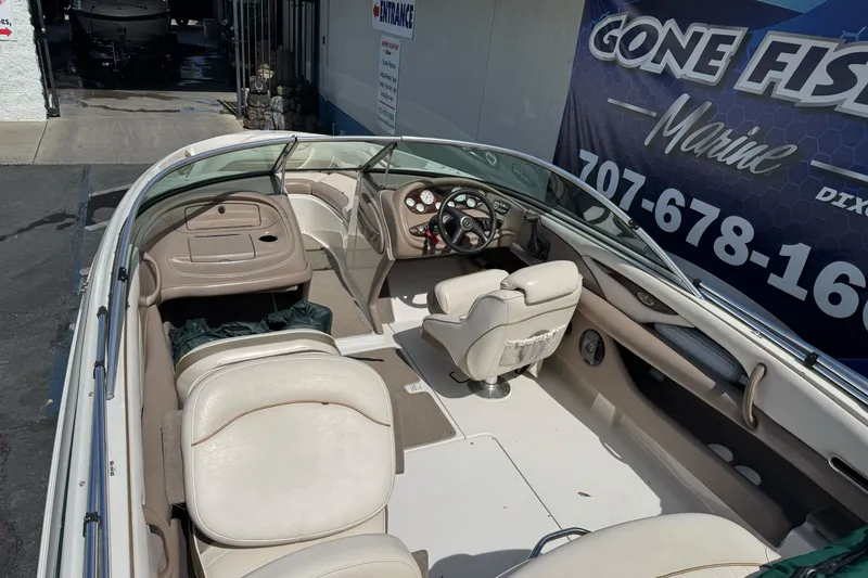 Slide: The Image of 2000 Monterey 190LS Montura boat interior with beige seating and steering wheel. - 10