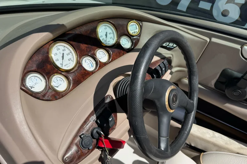 Slide: The Image of Dashboard of a 2000 Monterey 190LS Montura boat with gauges and steering wheel. - 19