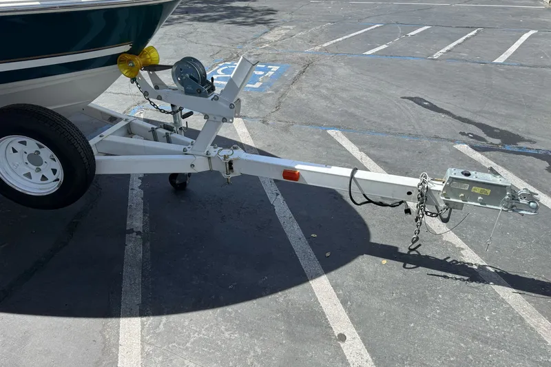 Slide: The Image of Trailer hitch of a 2000 Monterey 190LS Montura boat in a parking lot. - 3