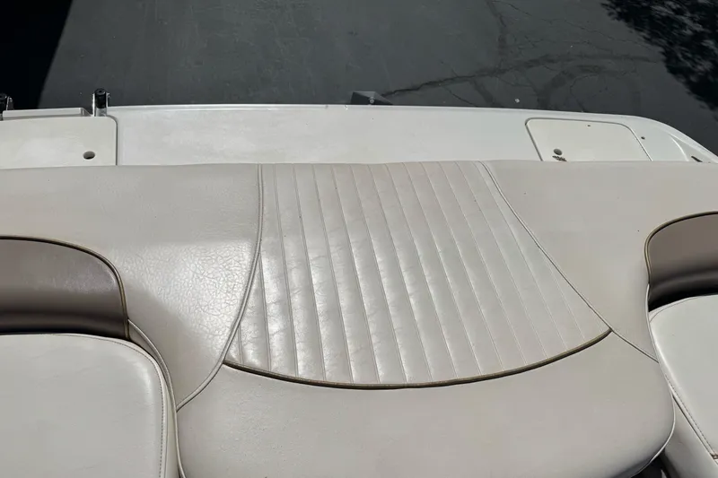 Slide: The Image of Rear seating area of a 2000 Monterey 190LS Montura boat, featuring beige upholstery. - 26