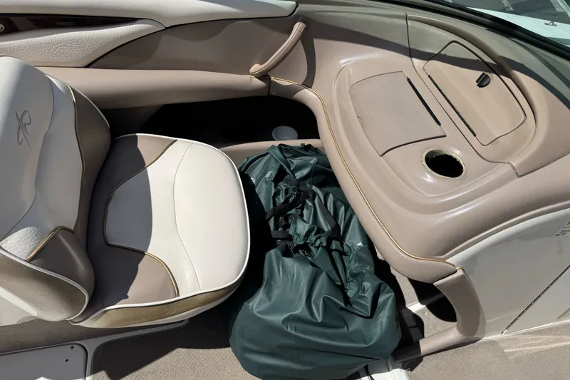Slide: The Image of Interior of a 2000 Monterey 190LS Montura boat with beige seating and storage area. - 20