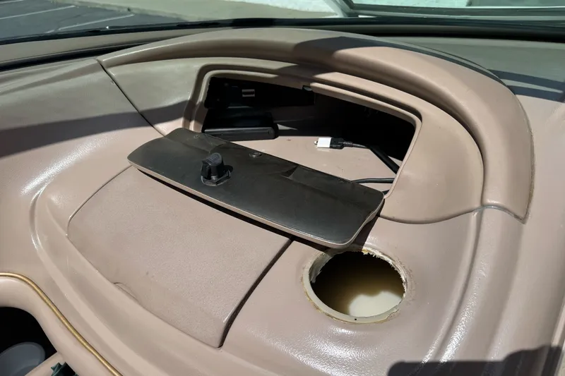 Slide: The Image of Dashboard compartment of a 2000 Monterey 190LS Montura boat with open storage and wiring. - 21