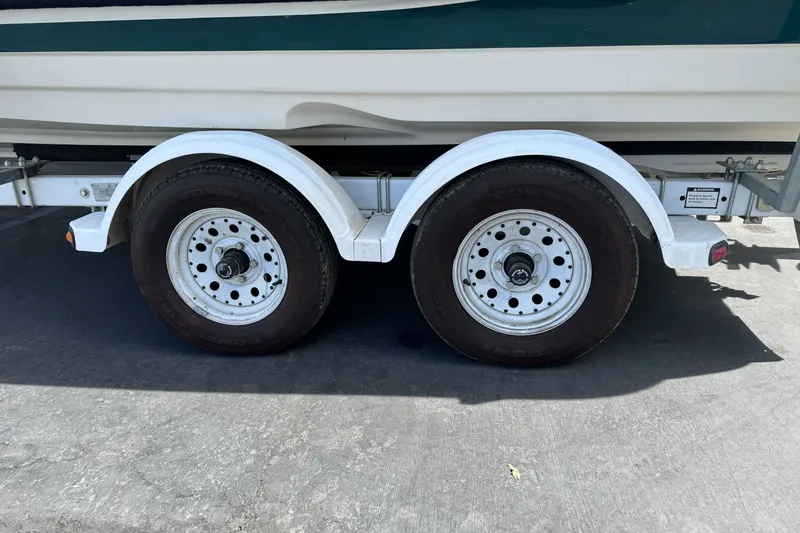 Slide: The Image of Trailer wheels of a 2000 Monterey 190LS Montura boat on pavement. - 8
