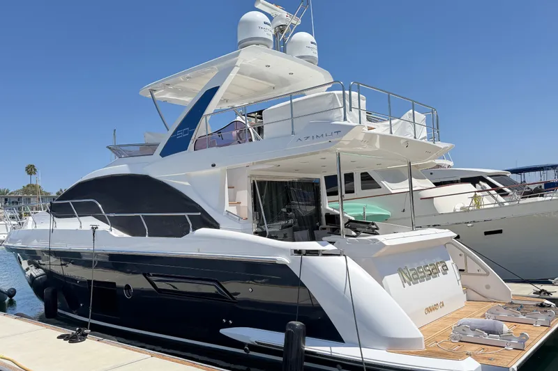 The Image of 2020 Azimut Fly 50 yacht docked at marina under clear blue sky. - 0