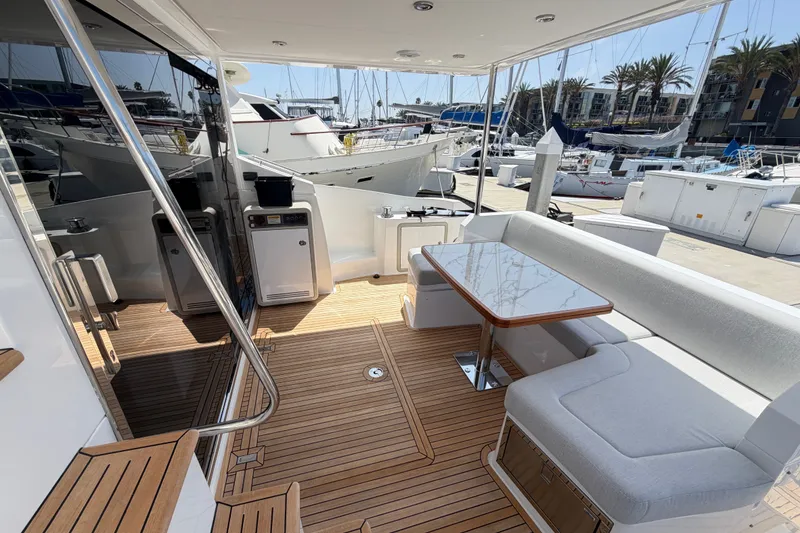 Slide: The Image of Azimut Fly 50 yacht deck with seating and table, docked at marina, 2020 model. - 14