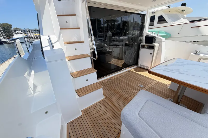 Slide: The Image of Luxurious 2020 Azimut Fly 50 yacht deck with elegant wood flooring and modern seating. - 13