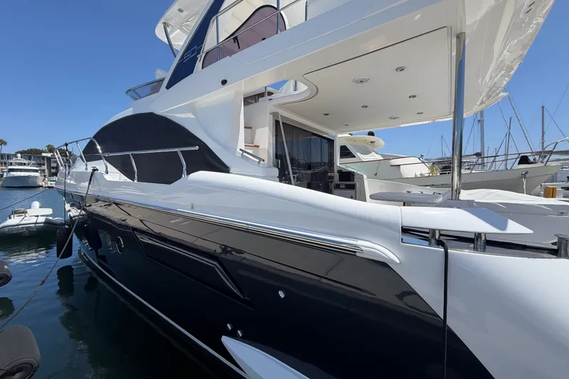 Slide: The Image of Luxury Azimut Fly 50 yacht, 2020 model, docked at marina under clear blue sky. - 1