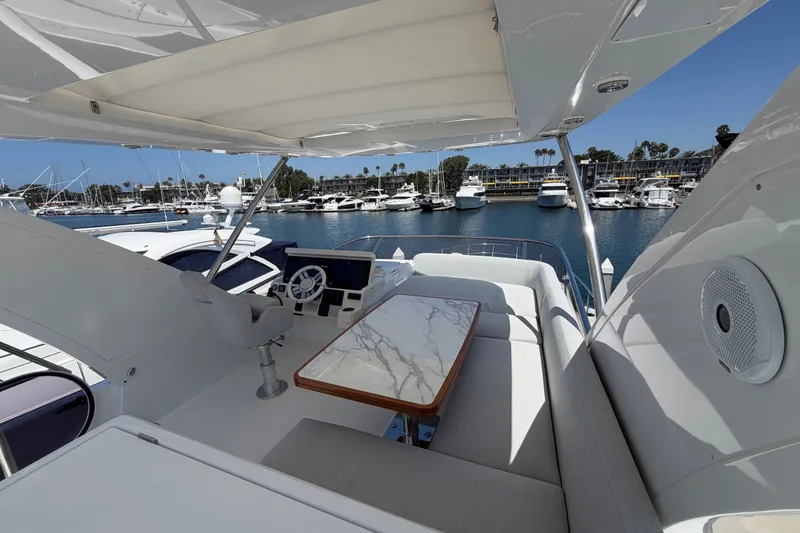 Slide: The Image of Flybridge of 2020 Azimut Fly 50 yacht with luxurious seating and marina view. - 6