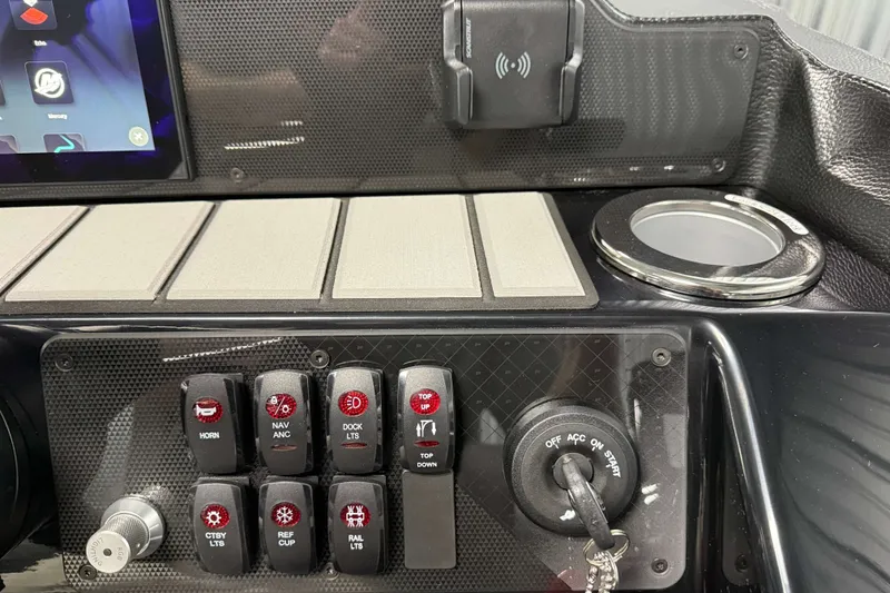 Slide: The Image of Control panel of 2026 Premier 230 Solaris RF Tritoon with switches and ignition key. - 13