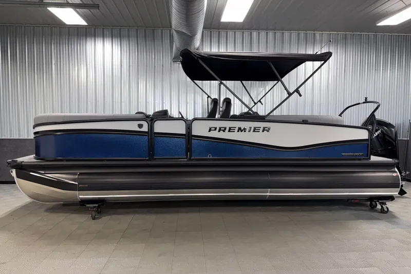 Slide: The Image of 2026 Premier 230 Solaris RF Tritoon in showroom, side view with canopy. - 31