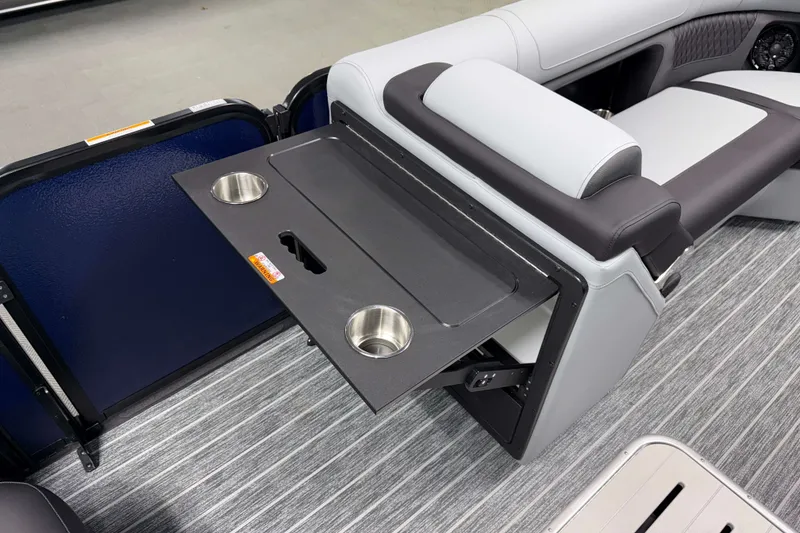 Slide: The Image of 2026 Premier 230 Solaris RF Tritoon interior with fold-out table and cup holders. - 18