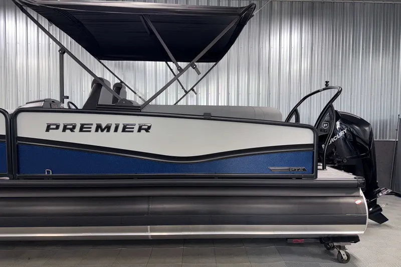 Slide: The Image of 2026 Premier 230 Solaris RF Tritoon boat with canopy in showroom. - 32
