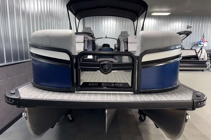 Slide: The Image of 2026 Premier 230 Solaris RF Tritoon boat in showroom, rear view. - 29