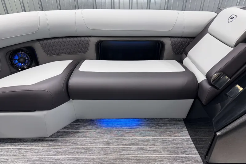 Slide: The Image of Luxurious seating in 2026 Premier 230 Solaris RF Tritoon with ambient blue lighting. - 26