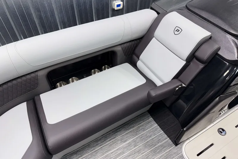 Slide: The Image of Luxurious seating on 2026 Premier 230 Solaris RF Tritoon boat, featuring sleek design and cup holders. - 25