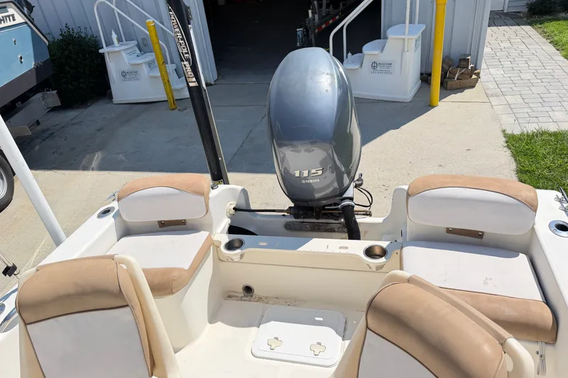 Slide: The Image of 2012 Scout 187 Sportfish boat with Yamaha 115 engine, docked outdoors. - 14