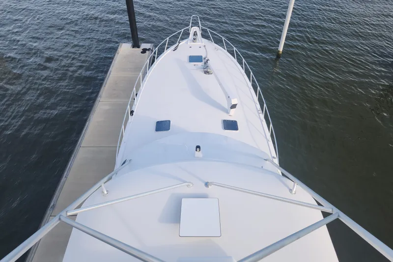 Slide: The Image of Aerial view of 1999 Hatteras 65 Convertible yacht docked by the water. - 57