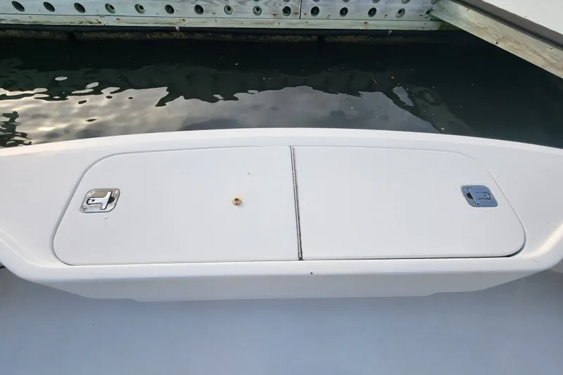 Slide: The Image of Hatteras 65 Convertible 1999 boat deck with storage compartments by the water. - 62