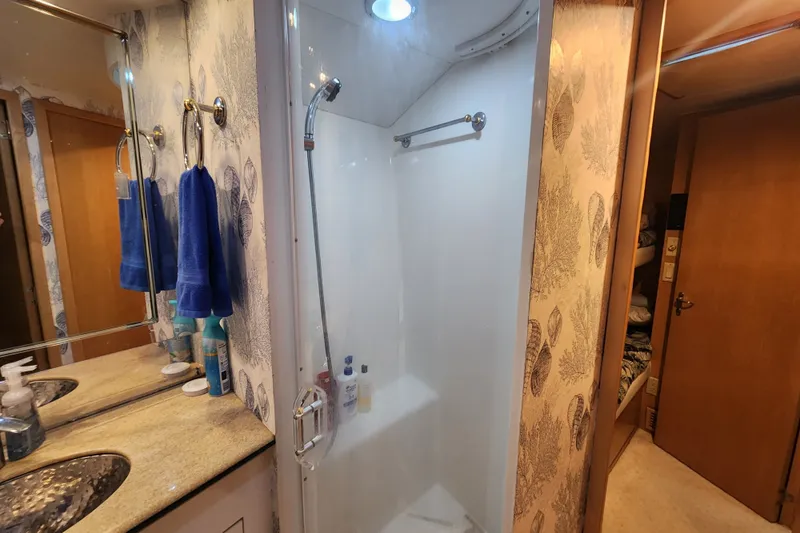 Slide: The Image of Bathroom interior of 1999 Hatteras 65 Convertible yacht with shower and vanity. - 28