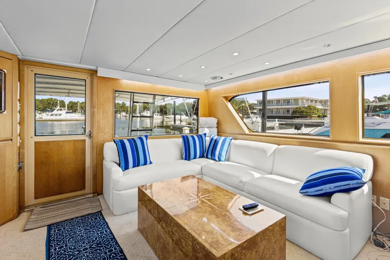 Slide: The Image of Luxurious interior of 1999 Hatteras 65 Convertible yacht with white sofa and blue accents. - 105